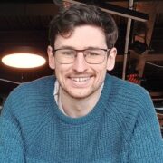 Man in blue jumper.