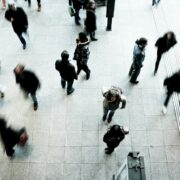 People walking across a crowded square.