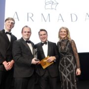 Three men and a woman at an awards night.
