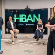 Two men and two women in a conference room.