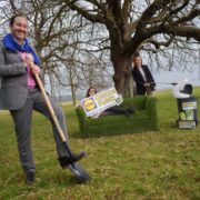 People in a field with a shovel.