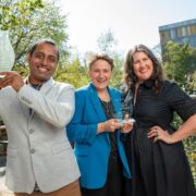 Man holding an award beside two women.