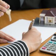 Woman signing a mortgage form.