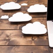 Clouds on a desk beside a laptop.