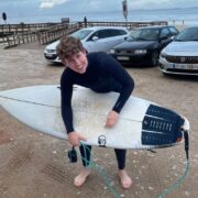 Young man with a surf board.