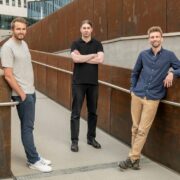 Three men outside a building.