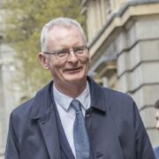 Man in suit walking on street.