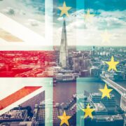 British flag and Euro flag over an image of the city of London.