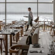 Waiter walks through restaurant at Armada Hotel.