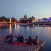 Group of people sitting by bay in Galway city.