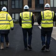 Three men wearing hi-vis jackets.