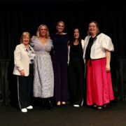 Five women on a stage.