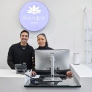 Woman and man behind counter of a Thérapie store.