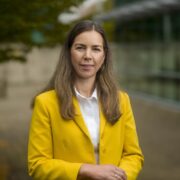 Woman in yellow jacket.