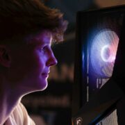 Young student entrepreneur in front of a purple PC fan.