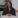 Woman in green blouse sitting at a table.