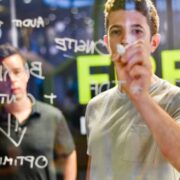 Man writing on a glass wall.