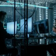 Two young employees of a business working at their computers.