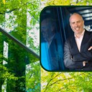 man in suit inset on image of a glass building swathed in green.