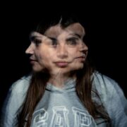 Woman with blurry face, indicating imposter syndrome doubts.