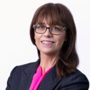 Dark-haired woman in business suit.