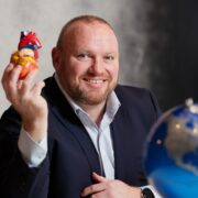 Man holding a model of a heart.