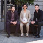 Two men and a woman with a football.
