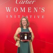 Woman holding award.