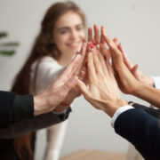 Team of people high-fiving.