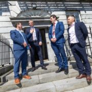 Four men standing on steps of a building in Limerick.
