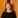 Smiling woman in black dress.