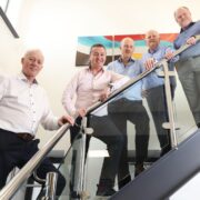 Five men on a stairs.