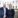 Man and woman in business attire in front of a white building at UCD.