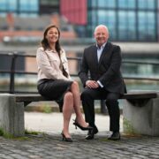 Woman and man sitting on a bench in Dublin.