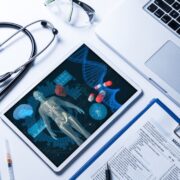 stethoscope beside tablet computer with diagram of human body.