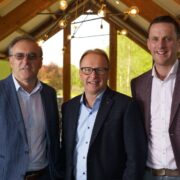 Three men in business suits.