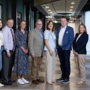 Group of men and women in a hall.