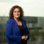 Woman wearing blue business suit.