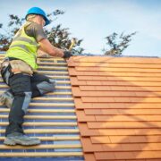 Builder tiling a roof.