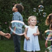 Young kids playing with bubbles.