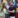 Young woman and man in front of a mural.