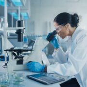 Woman in white lab coat at work.