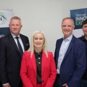 Three men and two women at a business event.