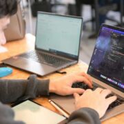 Schoolboy coding on a laptop.