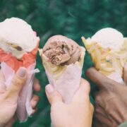 Three people holding ice cream cones.
