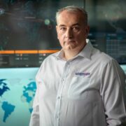 Man standing in cybersecurity control centre.
