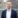 Man in navy blazer and white shirt.