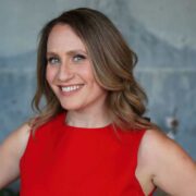 Smiling woman in red dress.