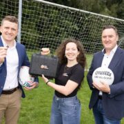 Two men and a woman demonstrating sports safety tech.