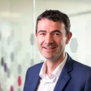 Dark haired man in blue suit.